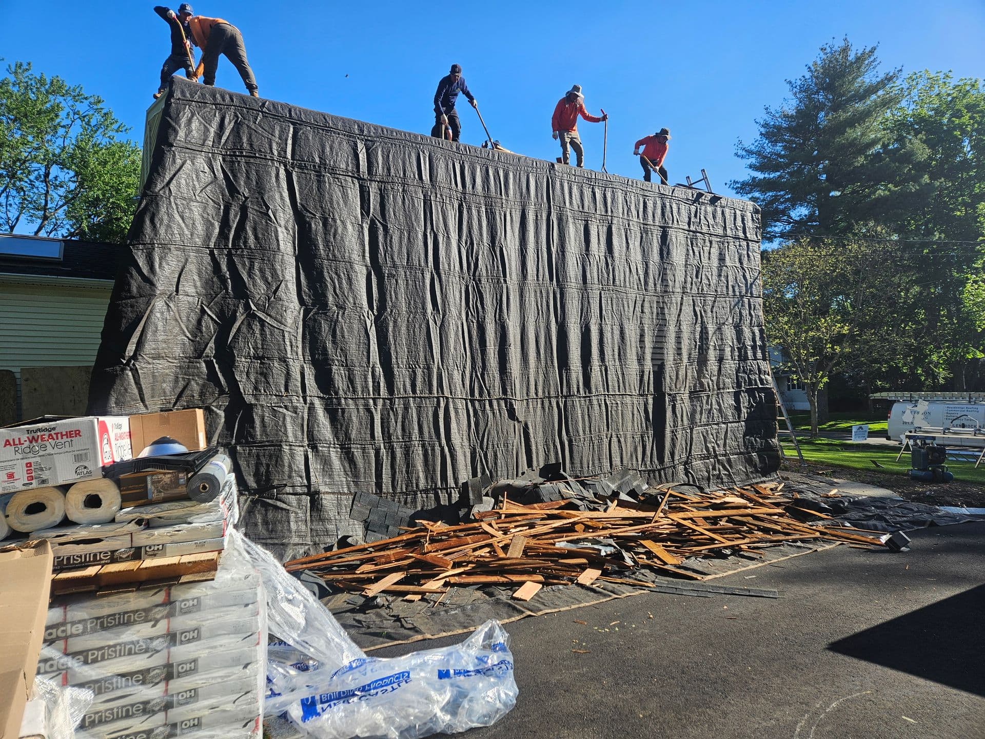 tarp protecting the side of the house during roof rip