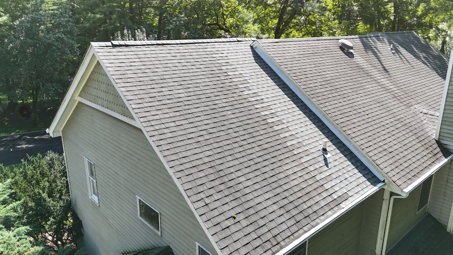 Mattsson Roofing shingle repair showing new lighter shingles next to older weathered shingles on a home in Saddle River, NJ.
