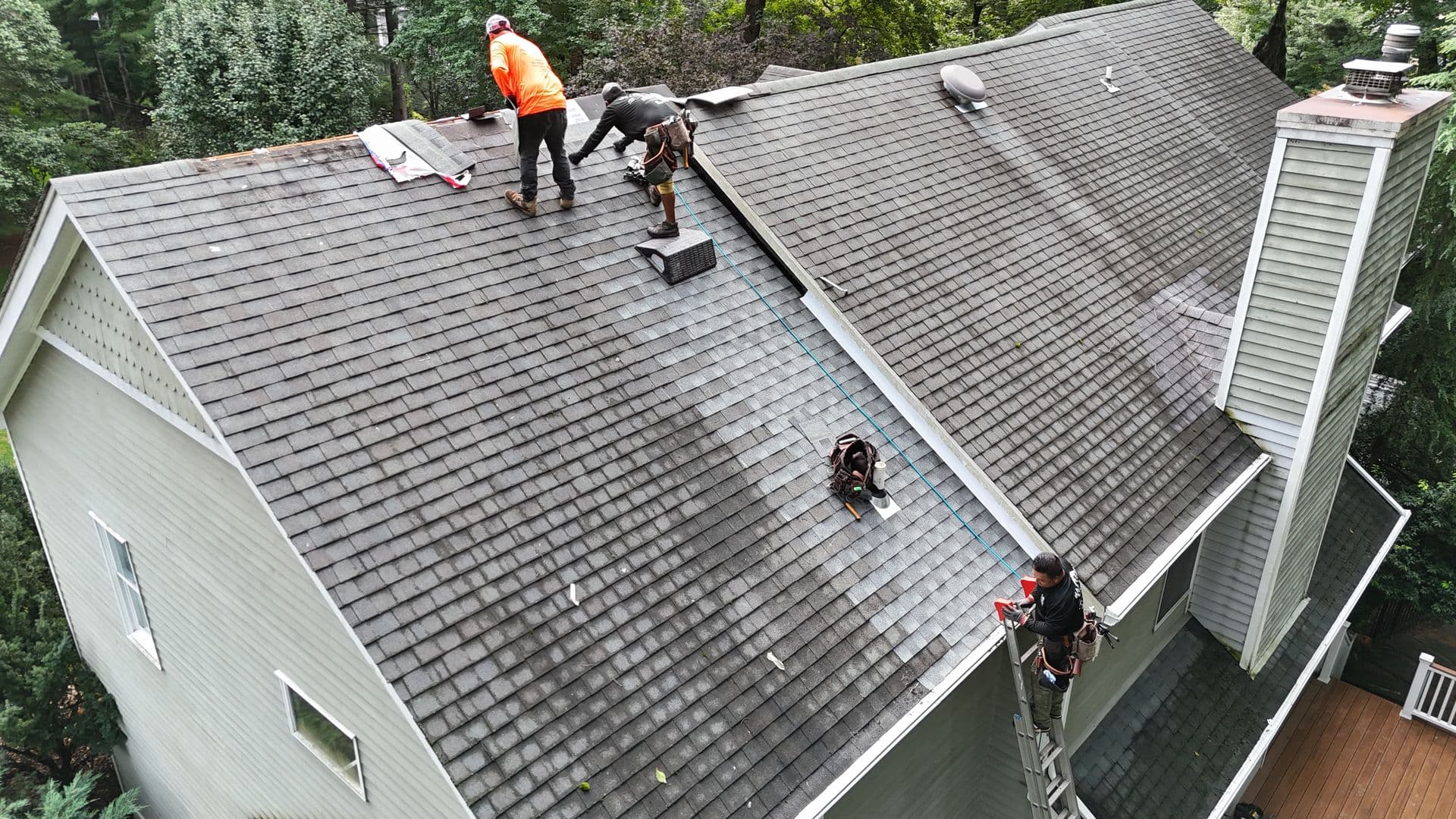Mattsson Roofing shingle repair showing new lighter shingles next to older weathered shingles on a home in Saddle River, NJ.